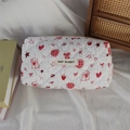 Close-up of quilted cosmetic bag with red heart and rabbit patterns and zipper closure - Pink Rabbit