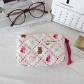 Detail of white quilted cosmetic bag with cute bunny bear prints and woven zipper pull - Dessert Rabbit