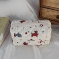 Close-up of quilted cotton storage bag with cute cartoon dog print and branded cloth label - Beige Dog