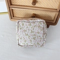 Close-up of a floral fabric storage bag with embroidery and silver metal zipper detail - Pink Green Floral