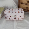 Detailed close-up of quilted pink makeup bag featuring cartoon patterns and May Rabbit label - Bear with Red Hat on Pink Base
