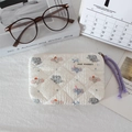 Detailed texture of white quilted mini bag with cute cartoon elephant prints and purple zip puller - Cute Elephant