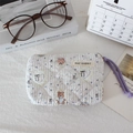 Detailed view of blue striped quilted cosmetic bag with cute bear patterns and purple zipper - Bear