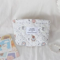 Detailed view of quilted makeup bag with cute bear patterns and blue stripes - Bear