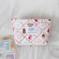 Detail of quilted floral cosmetic bag featuring cute cartoon rabbit and bear patterns - Dessert Rabbit