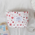 Close-up of white quilted cosmetic bag with cute red strawberry and bunny patterns - Pink Rabbit