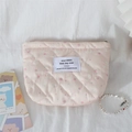Close-up of quilted pink fabric showing cute rabbit and strawberry patterns on makeup bag - Pink Strawberry Rabbit
