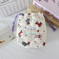 Close-up of quilted cotton drawstring camera bag with cute cartoon puppy patterns - Beige Dog