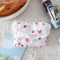 Close-up of quilted floral coin purse with lace trim on a vintage tablecloth - Pink Rabbit