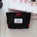 Detail of black jacquard satin makeup bag with red horse embroidery and zipper - Black Red Horse Lipstick Bag
