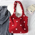 Close-up of red embroidered tote bag with white pom-pom hearts and metal snap button - Heart Red