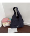Large navy canvas tote bag with side drawstring details on dark wood floor backdrop - Nylon Shoulder Strap With Laces On Both Sides: Navy Blue