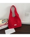 Detail of red nylon tote bag with drawstring side knots and woven brand label - Nylon Red With Ties