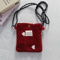 Detail of red plush mini crossbody bag with white heart pattern and braided strap - Heart / Red