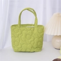 Detail of light green quilted handbag with 3D floral pattern and padded texture - Green