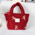 Close-up of red plush tote bag with embroidered bows and soft fleece texture - Large Bow Jujube Red