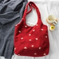 Detail of red wool tote bag featuring white bow embroidery and checkered lining - Small Bow Red