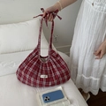 Red plaid cloud tote bag with ribbon bow and embroidered label on a white bed - Wine Red Plaid