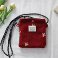 Detail of red plush mini bag with floral embroidery and woven drawstring strap - Mini Bowknot Necklace / Red