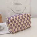 Detailed view of purple checkered knit makeup bag featuring soft texture and metal zipper - Yellow and Purple Grid