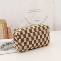 Close-up of brown checkered knit pouch featuring thick texture and silver zipper detail - Khaki Plaid