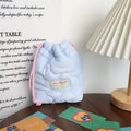 Detail of light blue quilted drawstring bag with cloud texture and pink cord closure - Quilted Cloud Light Blue