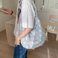 Light gray star pattern canvas tote bag with unique ruffled shoulder strap and logo patch - Drawstring Crossbody Strap: Full Grey Stars (Arc Bottom)