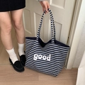 Blauw-wit gestreepte canvas draagtas met 'good' letteropdruk in academische stijl - Marine Streep
