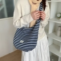Large striped crossbody bag in navy and grey with lace-trimmed label and adjustable strap - Drawstring Crossbody Strap: Navy Stripes (Arc Bottom)