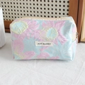 Detail of blue and pink floral embossed jacquard cosmetic bag with May Rabbit label - Stamen Pink Flower