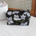 Macro view of floral jacquard fabric texture and brand label on the black pencil case - Oil Painting Black Grey Flower