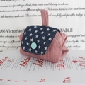 Macro detail of a corduroy coin purse featuring a star-patterned flap and blue button - Corduroy Nude Pink