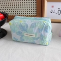 Detail of floral jacquard pencil case featuring a May Rabbit label and blue zipper closure - Blue-Green Decorative Flower