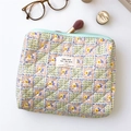 Detailed close-up of quilted floral cosmetic bag showing soft cotton texture and zipper - Green Plaid Floral