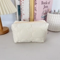Detailed close-up of cream quilted cloud makeup bag with soft texture and smooth zipper - Quilted Cloud Milky White