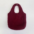 Close-up of the burgundy popcorn bubble texture and soft fabric on the shoulder tote bag - Purplish Red