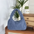 Detail of blue plush hobo handbag on a vintage wooden cabinet with plants - Blue