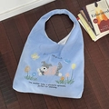 Light blue woolen hobo bag with dog embroidery and Do Dream text on wooden floor - Coil Puppy (Light Blue)