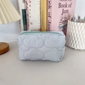 Close-up of light blue quilted cloud pouch with green zipper and metal pull tab detail - Quilted Cloud Light Blue