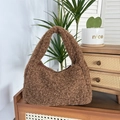 Detail of a brown plush tote bag with a soft texture placed on vintage wooden furniture - Brown