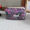 Close-up of floral jacquard texture and woven fabric on purple multipurpose storage bag - Purple Floral
