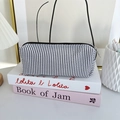 Detailed close-up of blue striped seersucker pencil case with sturdy black zipper - Navy Stripe