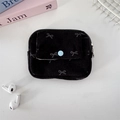 Macro view of black corduroy mini pouch with butterfly print and blue button closure - Black Bow