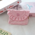 Detail of pink plaid mini pouch featuring a ruffle trim edge and round snap button - Pink Plaid
