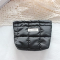 Detail of black quilted cosmetic bag with May Rabbit label on a lace background - Quilted Square Black