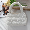 Detailed close-up of a white quilted puffer bag with cloud texture and top handle - Quilted Cloud Handbag / Creamy White