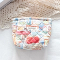 Detail of quilted cotton pouch featuring May Rabbit cartoon prints and a woven label - Rabbit Family