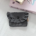 Detail view of mini black and white plaid storage bag with ruffle edge and button - Black and White Plaid