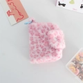 Close-up of pink leopard faux fur coin purse with blue plastic hook on cute desktop - Pink