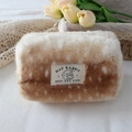 Close-up of soft plush deer pattern makeup bag with a detailed woven label on a lace desk - Snowflake Deer Pattern Medium Pen Bag